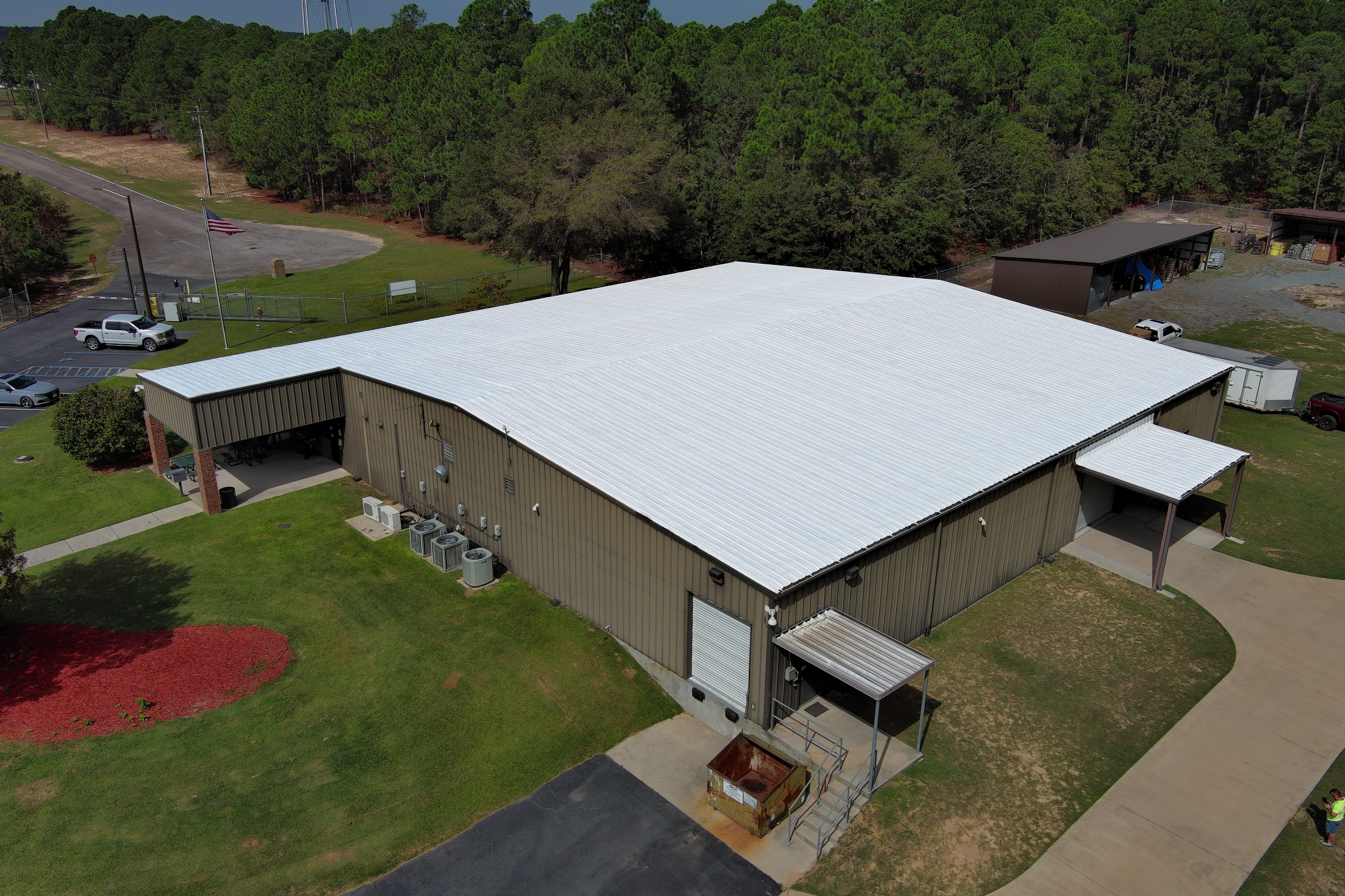 Professional metal roof coating application demonstrating superior restoration techniques and energy efficiency improvements up to 30%