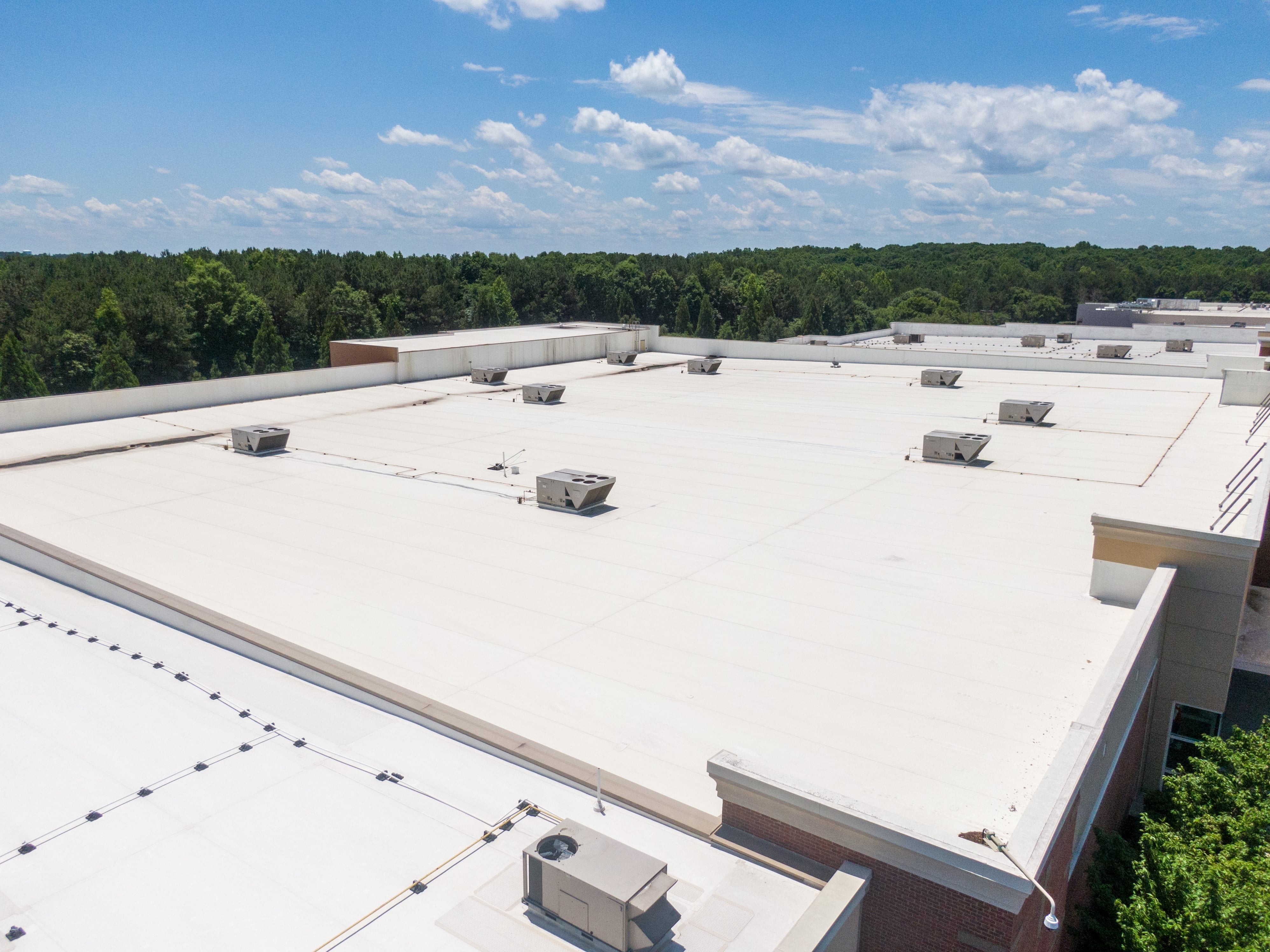 Commercial single-ply TPO restoration project demonstrating cost-effective solution that eliminates leaks and extends roof life by decades